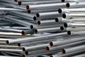 A lot of silver iron pipes piled up.