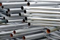 A lot of silver iron pipes piled up.