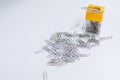 A lot of silver paper clip to white background.Magnetic box for put paper clips office supplies Royalty Free Stock Photo