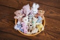 A lot of small toys in a wooden bowl, bears, bunnies, elephant, cat, fish