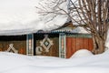 A lot of snow in Siberia. View of a snow-covered wooden fence, a gate and a wicket with a traditional pattern Royalty Free Stock Photo