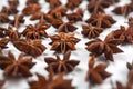 A lot of star anise on a white background close-up Royalty Free Stock Photo