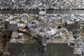 A lot of swarf and iron chips after cnc milling on workpiece and 4-jaw chuck holder Royalty Free Stock Photo