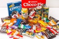 A lot of sweet snacks and drink jars on the table. Oreo, Choco-Pie, Ritter Sport, Haribo, Chupa Cups, YumEarth, Sanpellegrino,