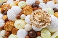 A lot of sweets, such as: marshmallows, sweets, chocolate, biscuits, nuts as a background or backdrop