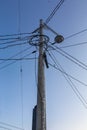 Pillar with wires against the blue sky Royalty Free Stock Photo