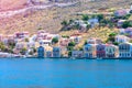 A lot of tiny colorful houses on the rocky shore of Mediterrenean sea on Simy greek island