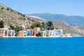 A lot of tiny colorful houses on the rocky shore of Mediterrenean sea on Simy greek island Royalty Free Stock Photo