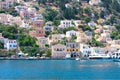 A lot of tiny colorful houses on the rocky shore of Mediterrenean sea on Simy greek island