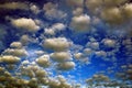 A lot of tiny gray and brown Clouds in a bright blue sky by oil Royalty Free Stock Photo