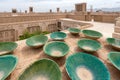 Lot of traditional green bowls on the roof of persian city. Clay bowls with rooftops of Yazd, Iran, in the background