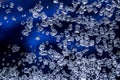 Closeup view of transparent white sugar crystals on dark blue background