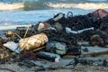 A lot of trash on the beach floating from the sea