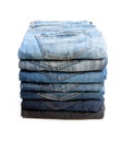 Lot of used jeans stacked in a pile isolated on white Royalty Free Stock Photo