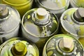 A lot of used spray cans of paint close-up. Dirty and smeared cans for drawing graffiti. The concept of a sweeping and careless d Royalty Free Stock Photo