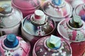 A lot of used spray cans of paint close-up. Dirty and smeared cans for drawing graffiti. The concept of a sweeping and careless d Royalty Free Stock Photo