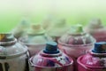 A lot of used spray cans of paint close-up. Dirty and smeared cans for drawing graffiti. The concept of a sweeping and careless d Royalty Free Stock Photo