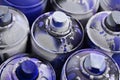 A lot of used spray cans of paint close-up. Dirty and smeared cans for drawing graffiti. The concept of a sweeping and careless d Royalty Free Stock Photo