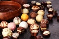 A lot of variety chocolate pralines, belgian confectionery gourmet chocolate on rustic dark background