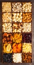 A lot of variety nuts and dried fruits in a wooden box, flat lay, top view