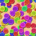 Vibrant colored vintage clothing plastic buttons randomly scattered on the wood background - top view Royalty Free Stock Photo