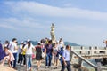 A lot of visitors standing and taking picture in front of the landmark of Zhuhai city of China. Statue of Fish Woman