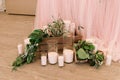 It is a lot of white candles on a floor near a table Royalty Free Stock Photo