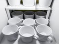 lots of white cups. Top view on many stacked in rows of empty clean white cups for tea or coffee Royalty Free Stock Photo