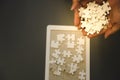 Lot of white jigsaw on hand, top angle view Royalty Free Stock Photo