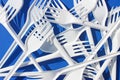 A lot of white plastic forks close-up on a blue background Royalty Free Stock Photo