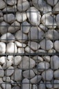 A lot of white polished pebbles behind a metal grid