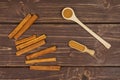 Dry brown cinnamon on brown wood Royalty Free Stock Photo