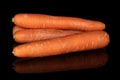 Fresh orange carrot isolated on black glass Royalty Free Stock Photo