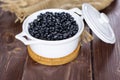 Raw black turtle beans on brown wood Royalty Free Stock Photo