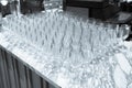 A lot of wine glasses in a row .Empty clean glasses standing in a row on a table prepared by the bartender for champagne and wine Royalty Free Stock Photo