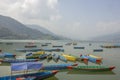 lot of wooden colored boats on the lake in the daytime against the backdrop of the mountains Royalty Free Stock Photo