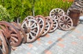 A lot of wooden wheels from old carts in disorder, piled in the Royalty Free Stock Photo