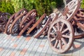 A lot of wheels from old carts in disorder, piled in the yard Royalty Free Stock Photo