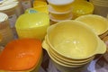 A lot of yellow bright plastic bowls and boxes kitchenware on a table Royalty Free Stock Photo