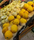 a lot of yellow melons on the counter at the shop