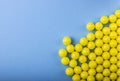 A lot of yellow round vitamins on a blue background Royalty Free Stock Photo