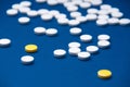 Lots of antibiotic pills close up on a blue background to treat the disease