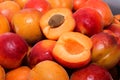 Lots of apricots. Fruit with a stone divided into 2 parts on the background of juicy apricots Royalty Free Stock Photo