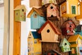 lots of beautiful multi-colored wooden decorative birdhouses on the tree. Royalty Free Stock Photo