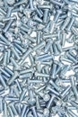 Lots of big industrial galvanized screws on a pile on white background Royalty Free Stock Photo