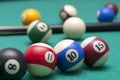 Lots of billiard balls and a cue closeup, macro shot of a professional competitive billiard table