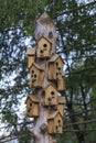 Lots of birdhouses hanging on a wooden pillar, houses for birds, handmade, small house for birds , Ukraine, closeup