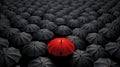 Lots of black umbrellas with one red umbrella in the middle created with Generative AI Royalty Free Stock Photo
