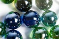 Lots of blue and green glass balls, beads on a white background, close-up Royalty Free Stock Photo