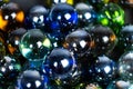 Lots of blue and green glass balls, beads on a white background, close-up Royalty Free Stock Photo